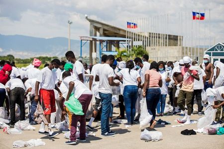 Angry scenes at Haiti airport add to Biden pressure over expulsions