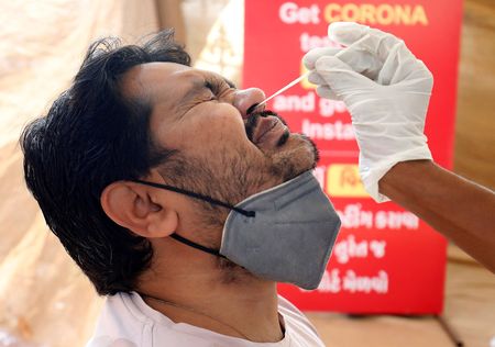 Masks come off, rallies begin as India’s COVID-19 patient load falls